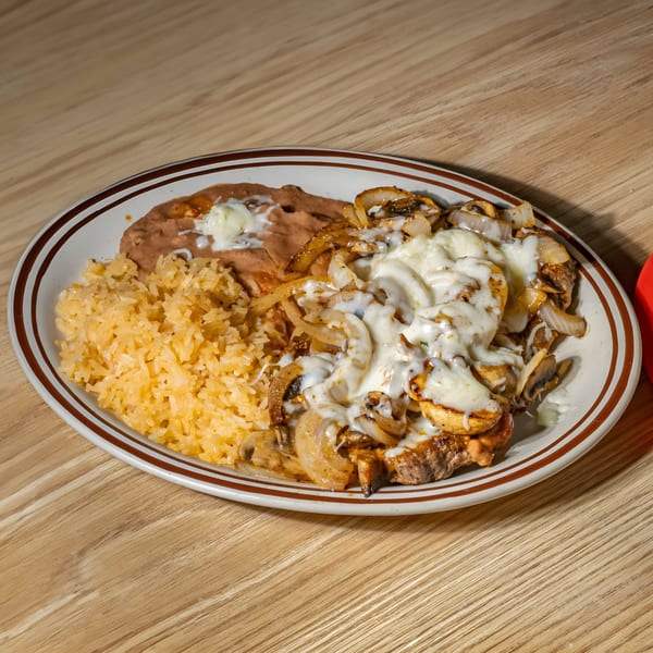 Mexican dish with grilled steak, onions, mushrooms, melted cheese, rice, and refried beans.